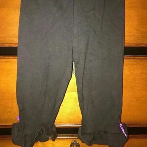 BLACK PANTS WITH PURPLE BOWS @ HEM/RUFFLE 12-18M